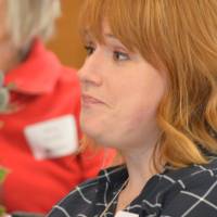 An alumna engaged in listening to a speaker
